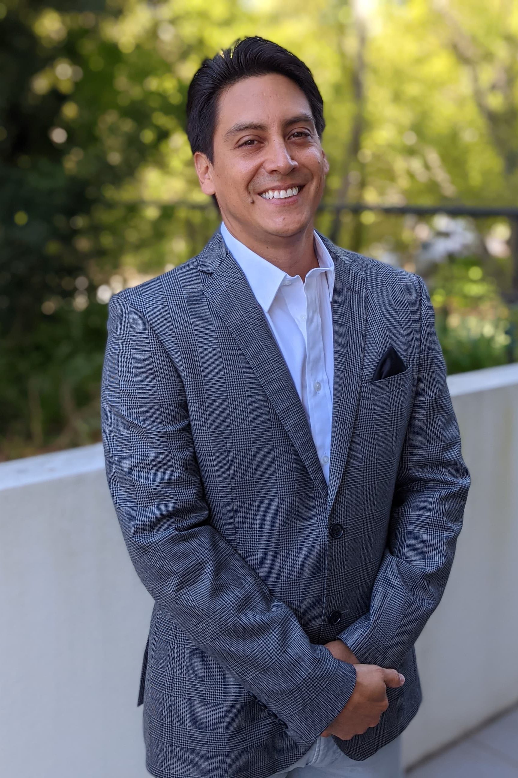 Santiago Ruiz smiling on semi-formal outfit